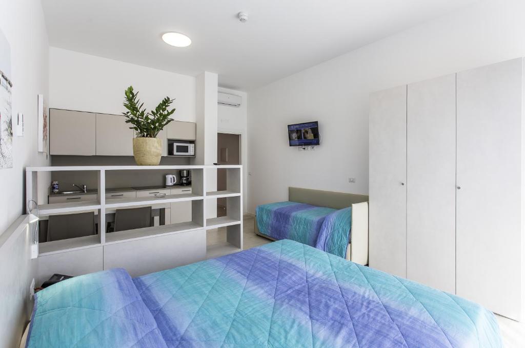 Кровать или кровати в номере Residenza Turistica Alberghiera Blue Marine