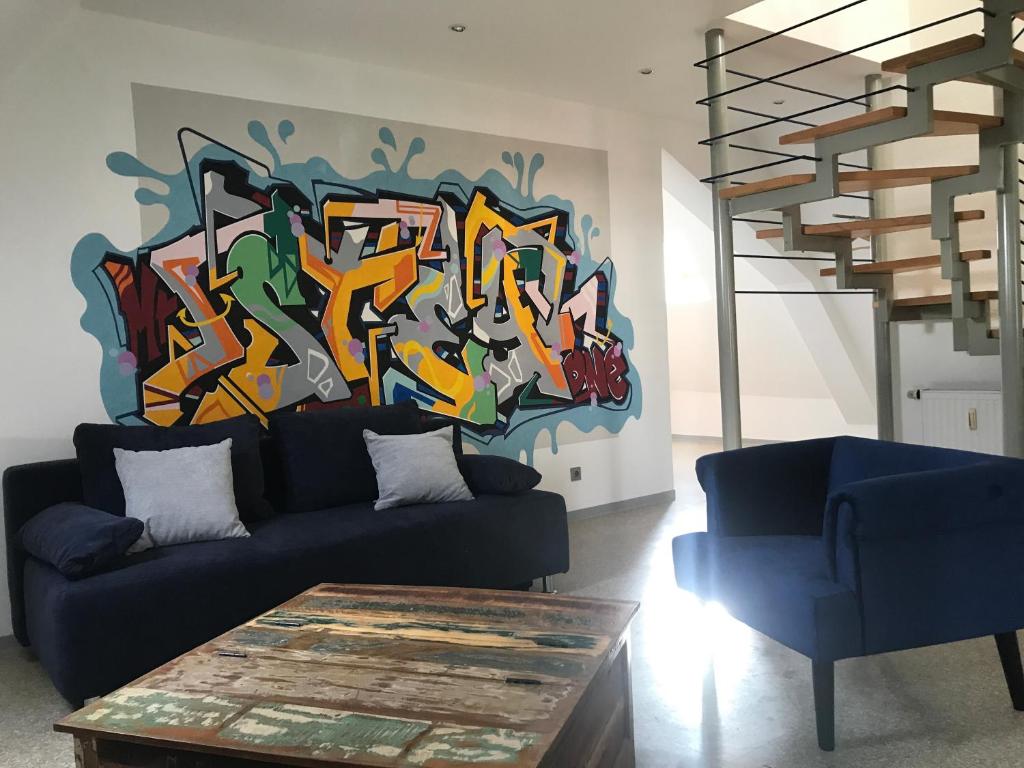 a living room with a painting on the wall at Münch 10 in Kaiserslautern