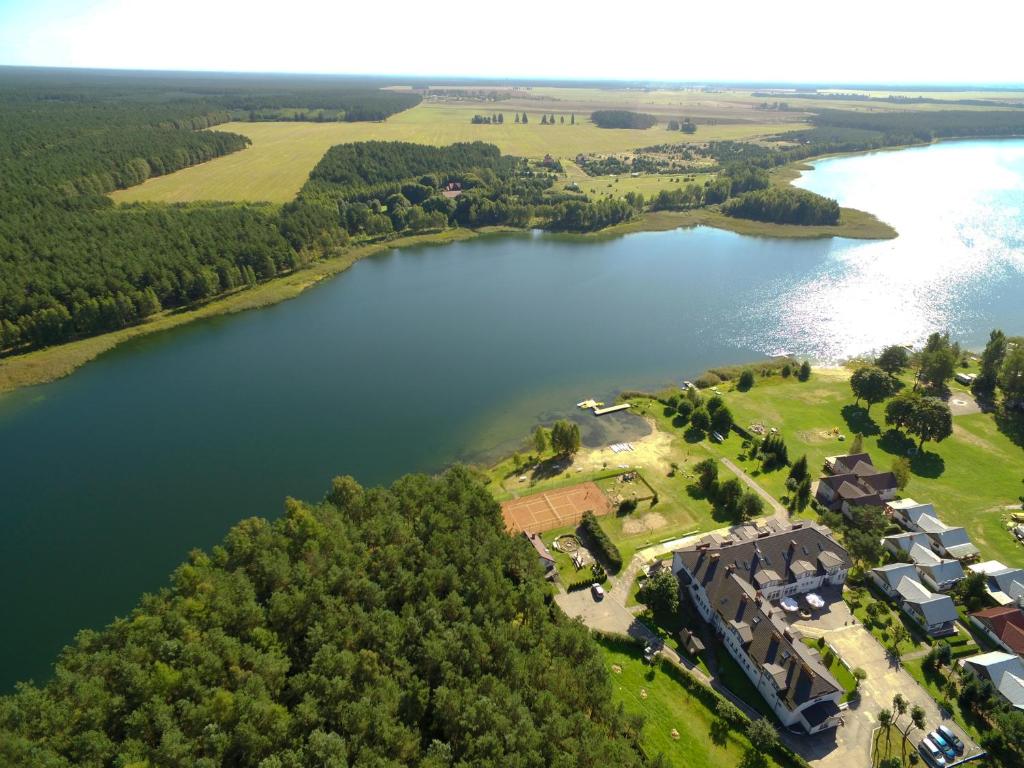 an aerial view of a house and a lake at Ośrodek Wczasowy BOBO in Koczała