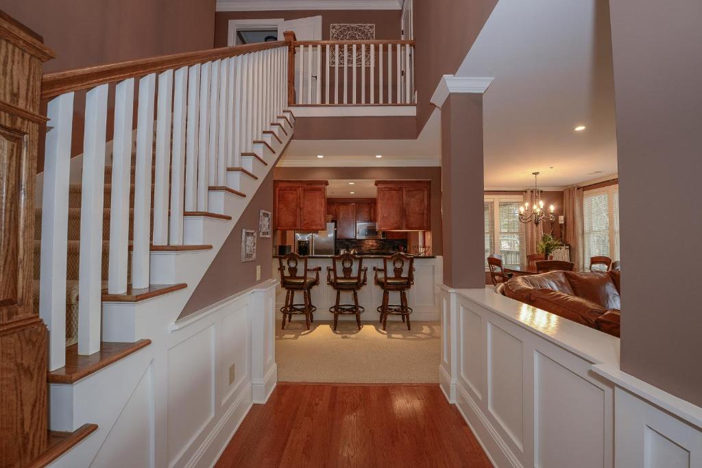 a home with a staircase and a living room at The Village Condo in Greensboro