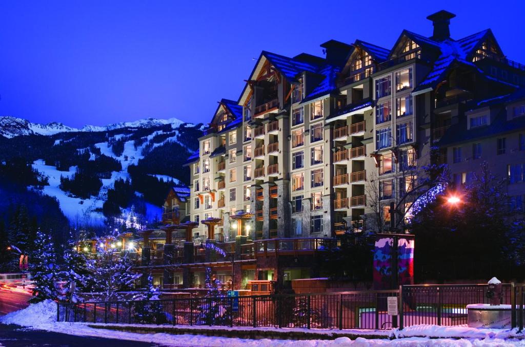 a large building with a sky background at Pan Pacific Whistler Village Centre in Whistler