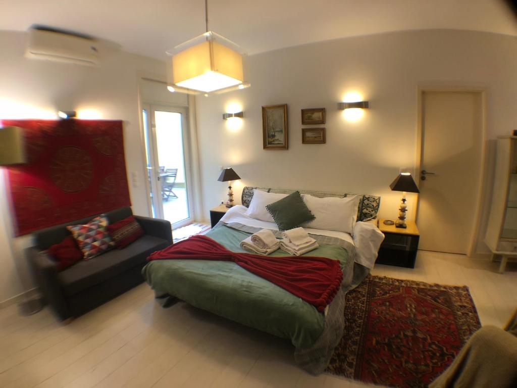 a bedroom with a bed and a couch in it at BS VILLAS RC PORTO in Porto