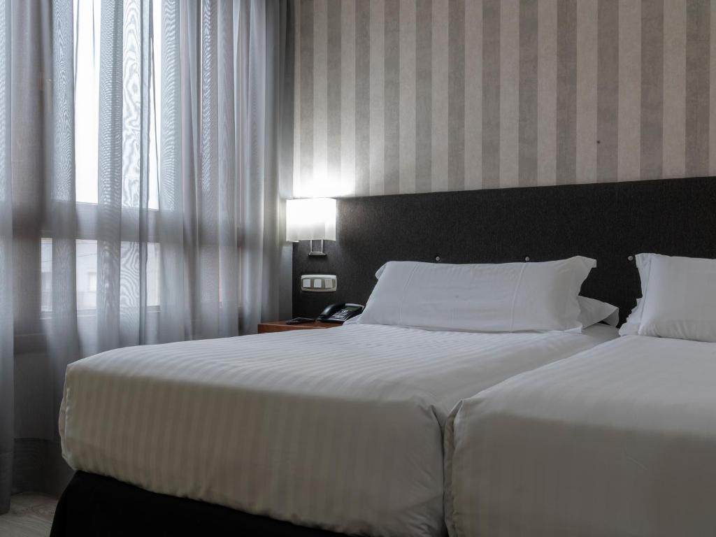 Postel nebo postele na pokoji v ubytování Hotel Plaza Las Matas