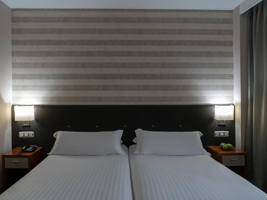 Postel nebo postele na pokoji v ubytování Hotel Plaza Las Matas