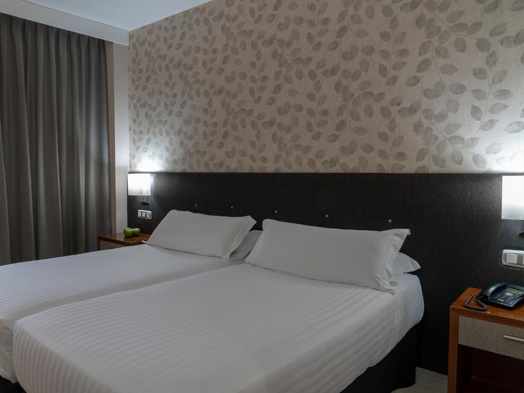 Postel nebo postele na pokoji v ubytování Hotel Plaza Las Matas