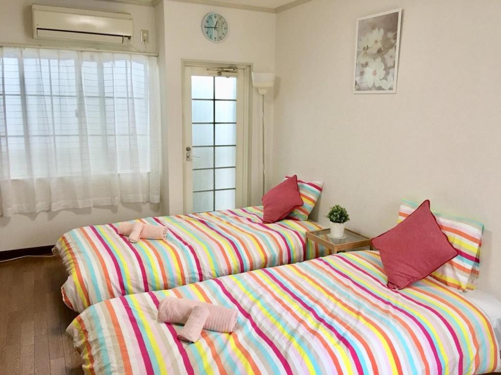 a bedroom with two beds with towels on them at 2-8-9 Jusohommachi - House / Vacation STAY 1677 in Osaka