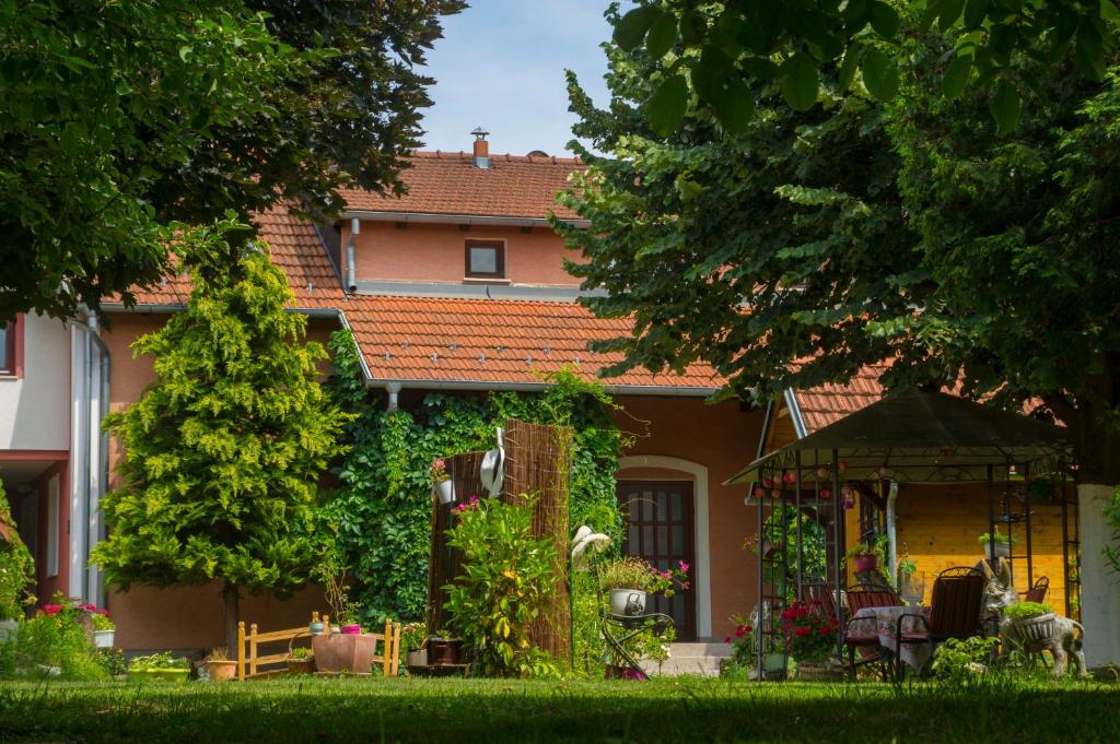 a house with a garden and a gazebo at Apartments Suncani in Zagreb