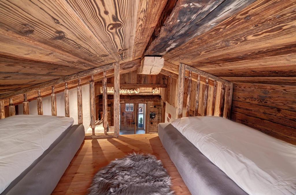 Postel nebo postele na pokoji v ubytování Highking Chalet Grünegg