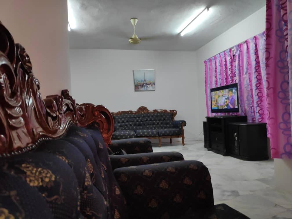 a living room with two chairs and a couch at Homestay PD in Port Dickson