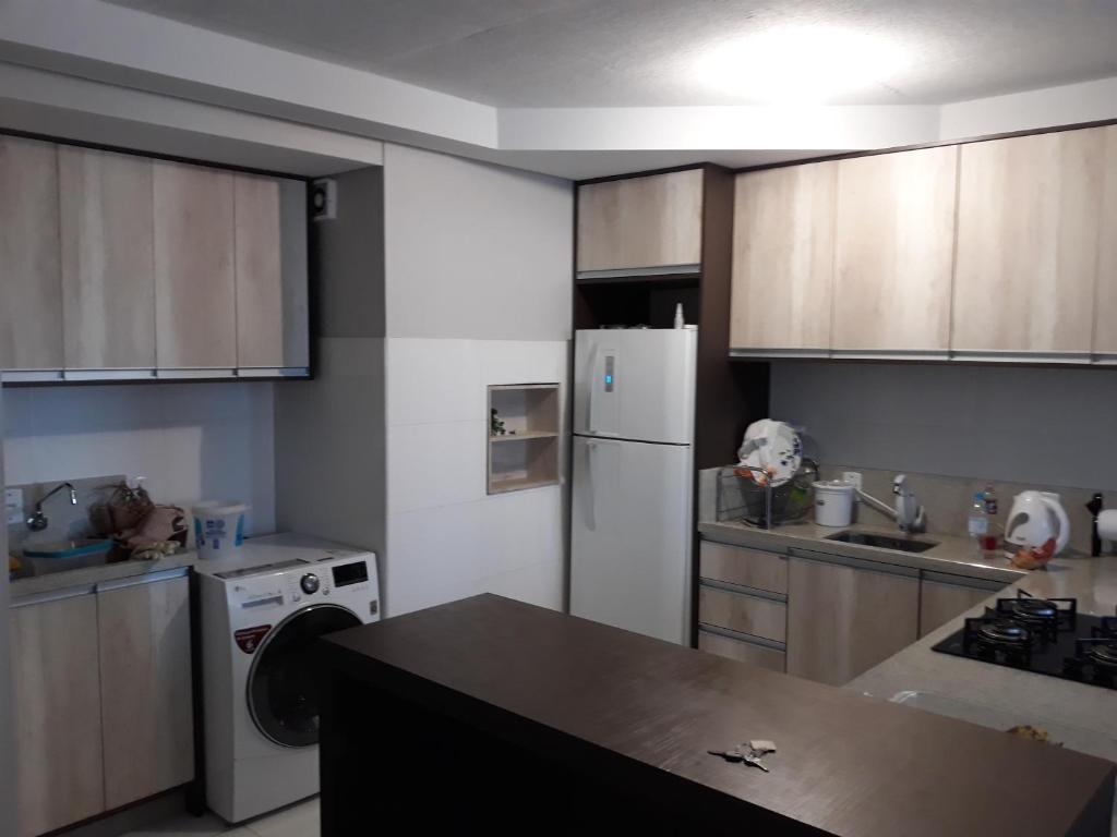 a kitchen with a white refrigerator and a stove at Apto prox. BR470 in Bento Gonçalves