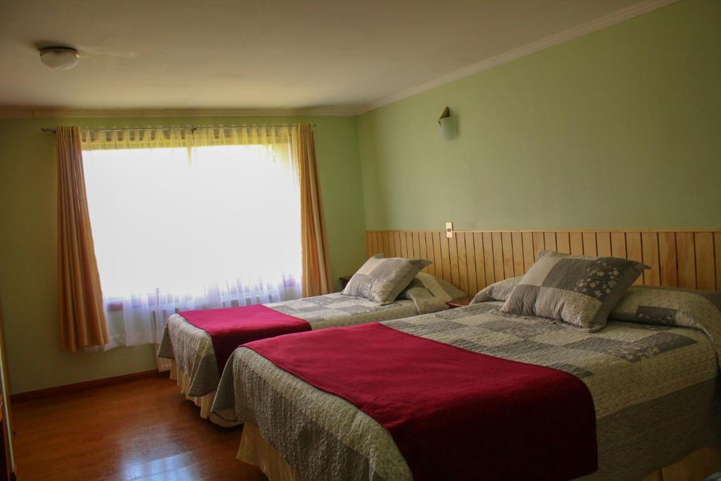 En eller flere senge i et værelse på Cabañas Parque Del Lago