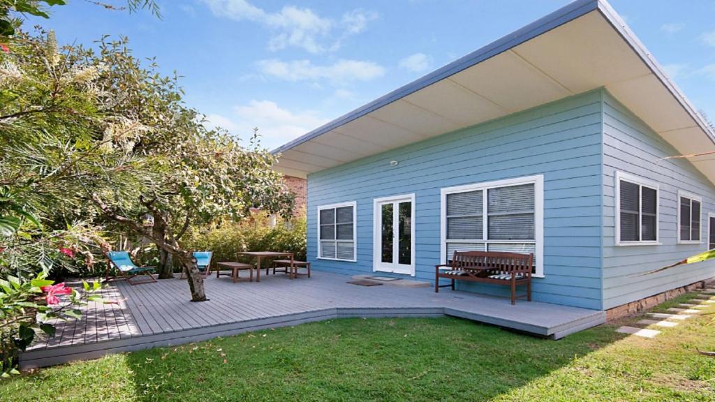 a blue house with a picnic table and a patio at My Blue Heaven - Dog Friendly in Lennox Head