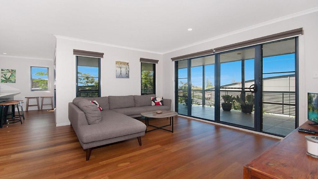 a living room with a couch and a table at KK's in Lennox Head