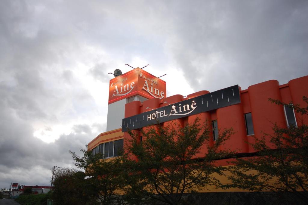 a red building with a sign on top of it at Koriyama Aine Adult Only in Koriyama