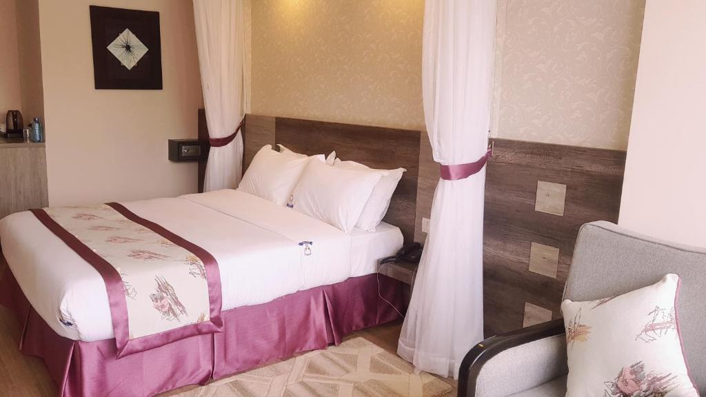 Postel nebo postele na pokoji v ubytování Merica Hotel