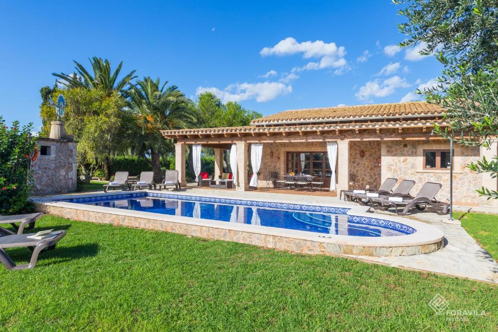 a swimming pool in the yard of a house at Son March in Sa Pobla