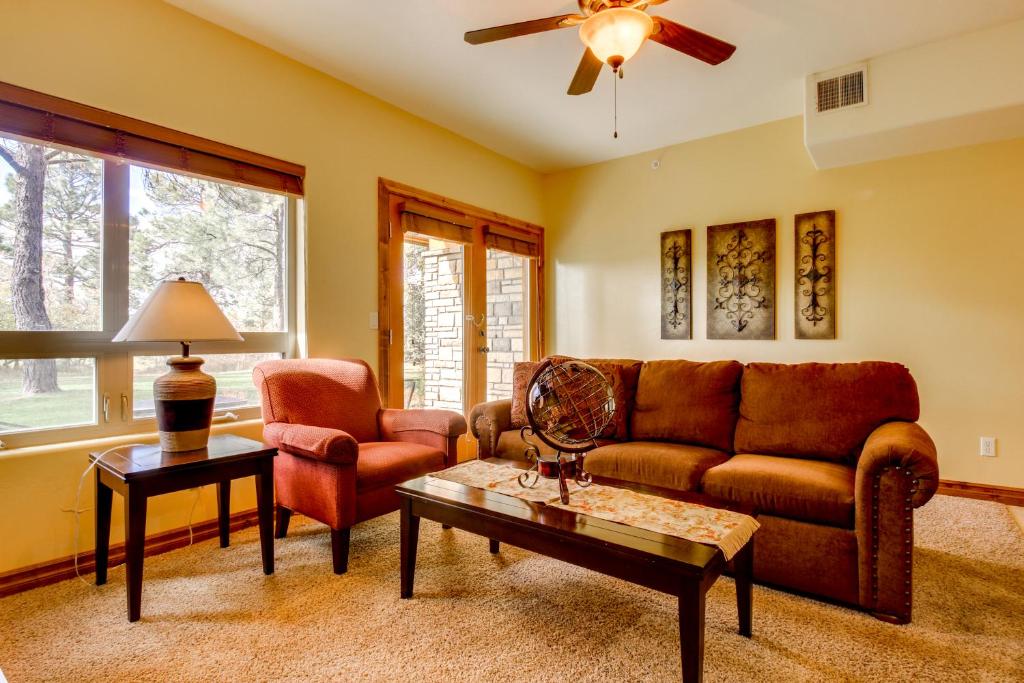 a living room with a couch chair and a table at Ace Condos in Pagosa Springs