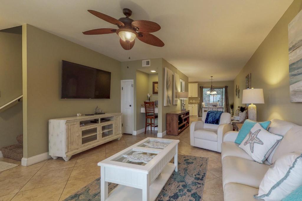 a living room with a couch and a flat screen tv at Gulf Winds #39 in Destin