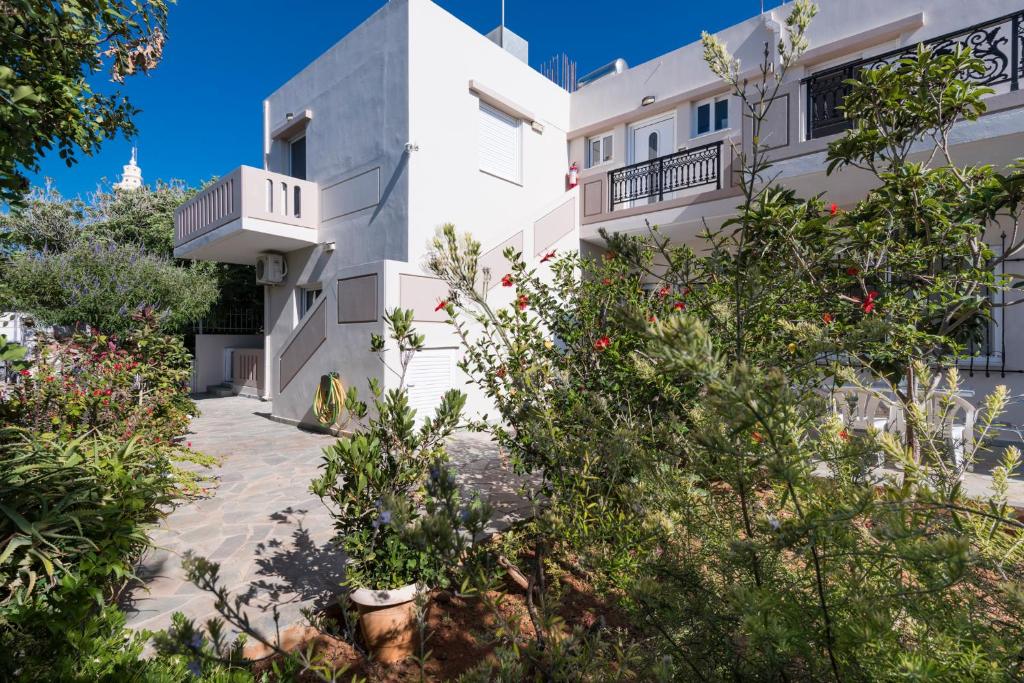 a white building with plants in front of it at Niki's Apartment in Palaiochóra