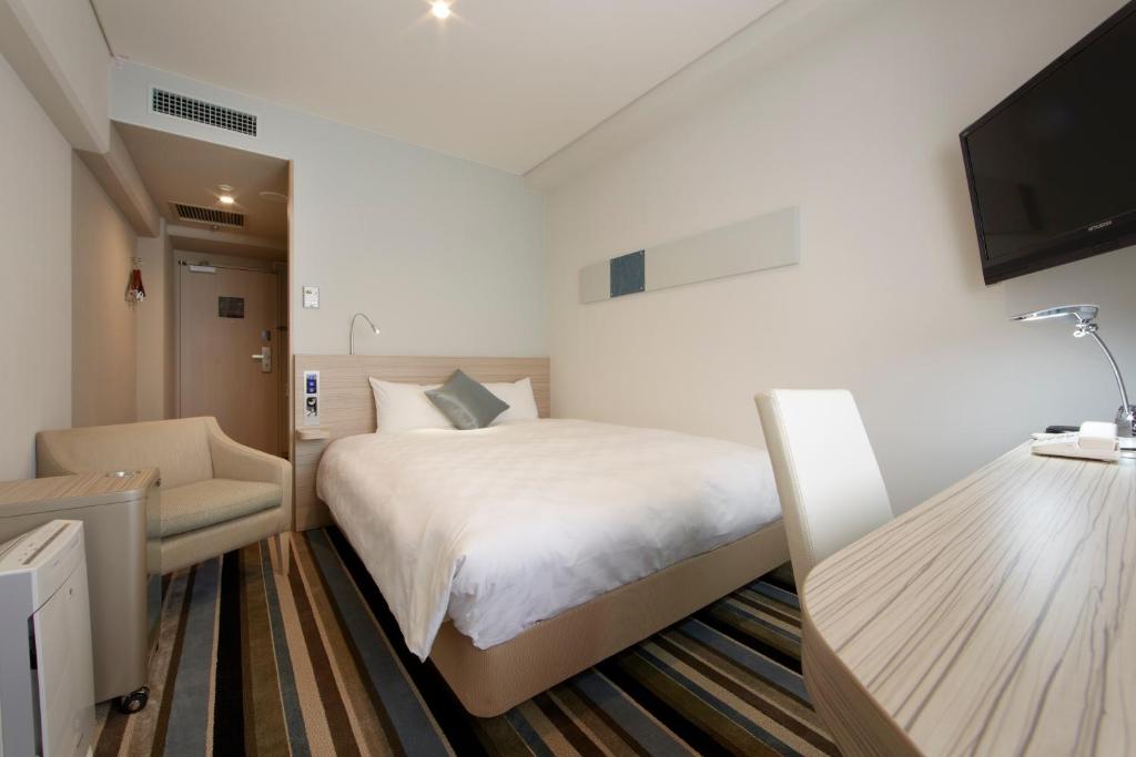 a hotel room with a bed and a flat screen tv at Shinagawa Prince Hotel N Tower in Tokyo