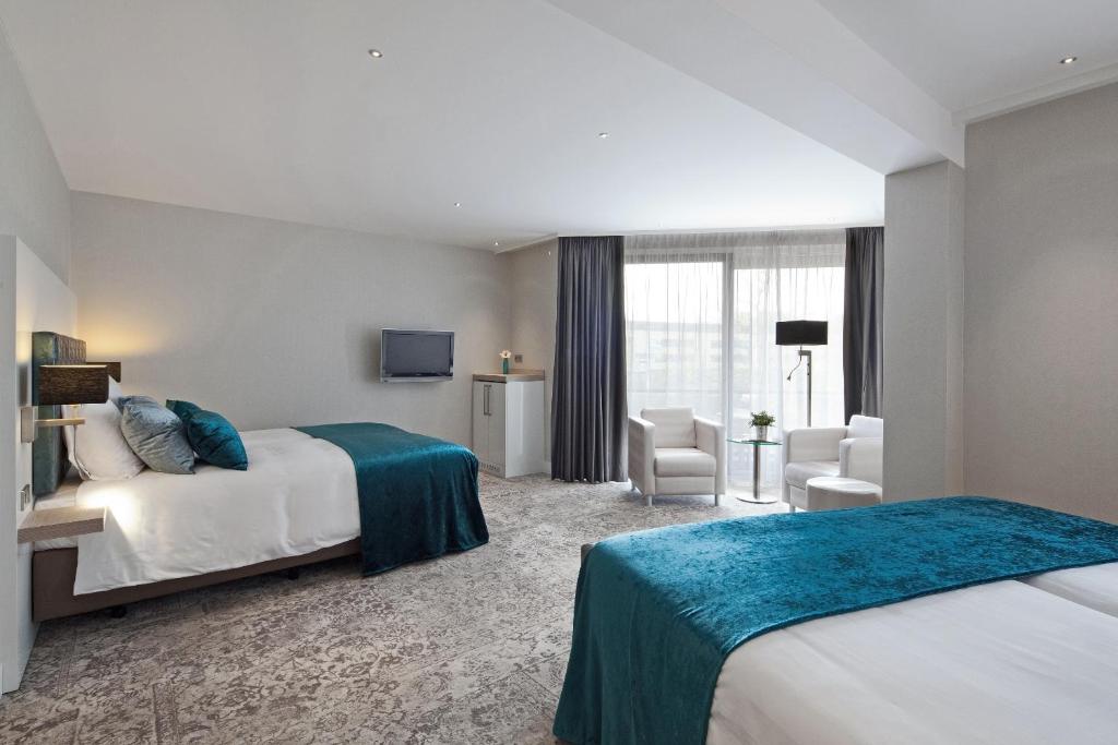 Postel nebo postele na pokoji v ubytování Van der Valk Hotel Leiden