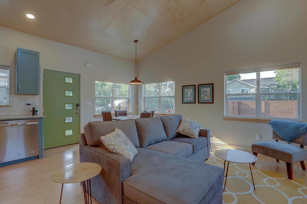a living room with a couch and a kitchen at Mod Pod in Bend