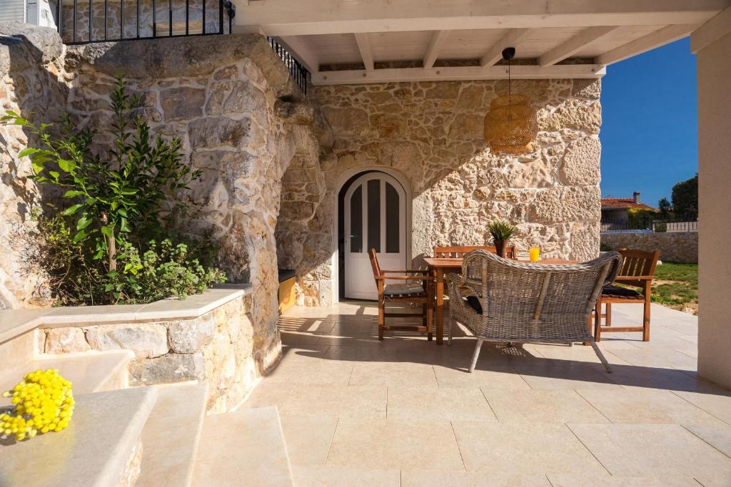 an outdoor patio with a table and chairs at House Misto in Dobrinj
