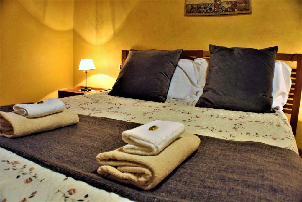 a large bed with towels and pillows on it at Appartamento Ernesto in Pistoia