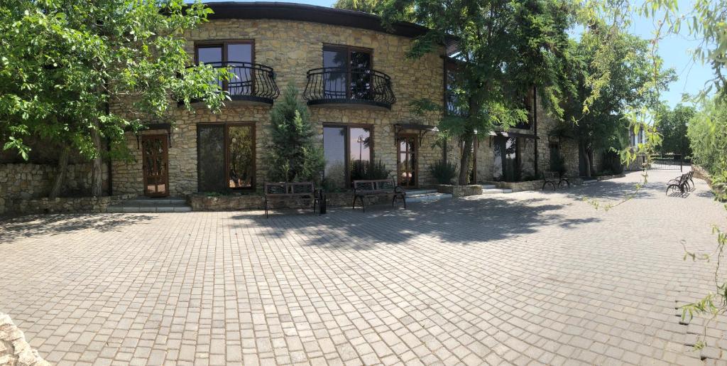 a brick building with a patio in front of it at Holiday Village Katrin in Nova Kakhovka