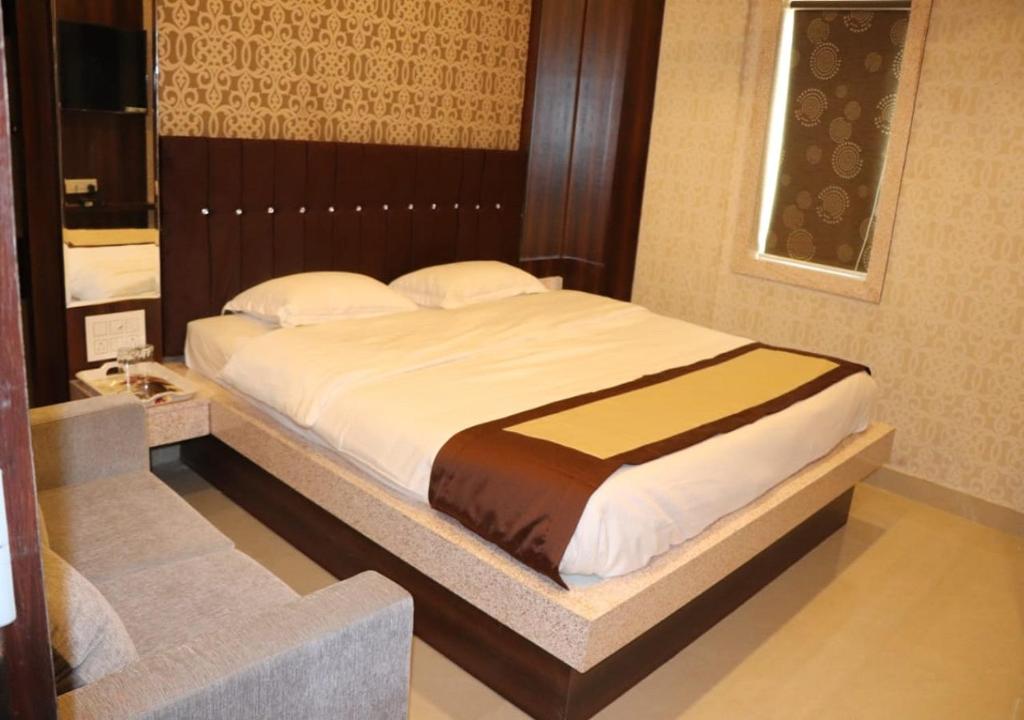a bedroom with a large bed in a room at Hotel Angina in Kolkata