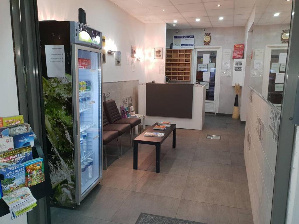 a room with a couch and a table in a store at Hotel Victory in Marseille