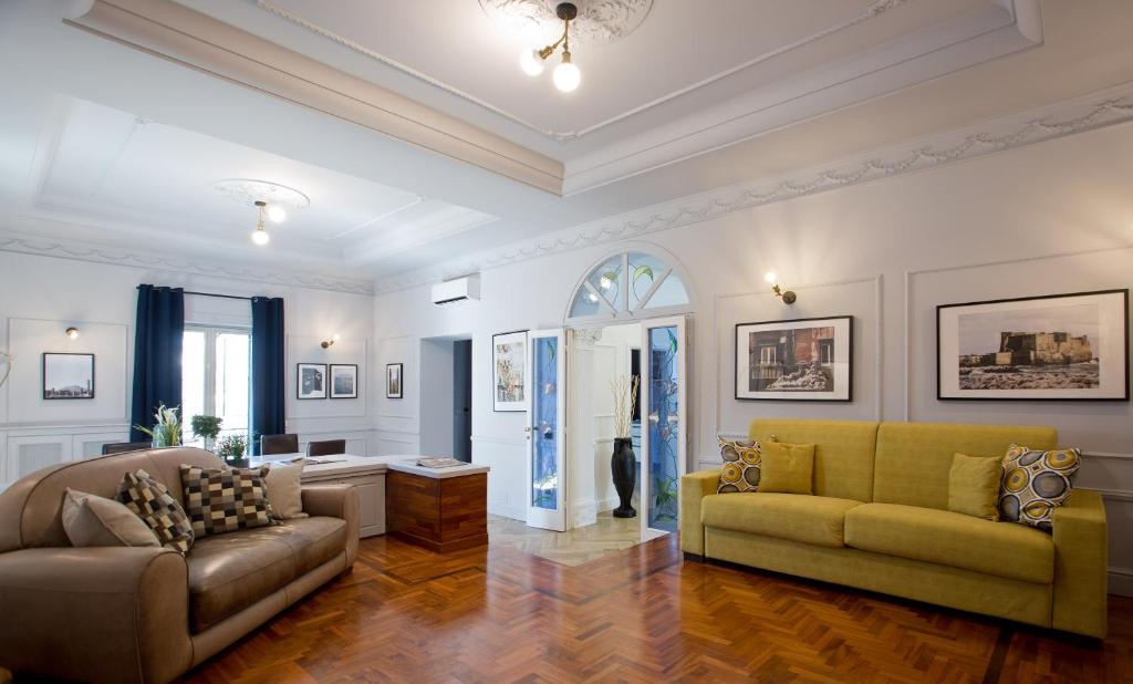 a living room with a couch and a table at Stylish apartment in the center of Naples by Wonderful Italy in Naples