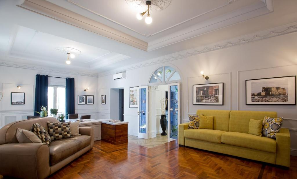 ein Wohnzimmer mit einem Sofa und einem Tisch in der Unterkunft Stylish apartment in the center of Naples by Wonderful Italy in Neapel