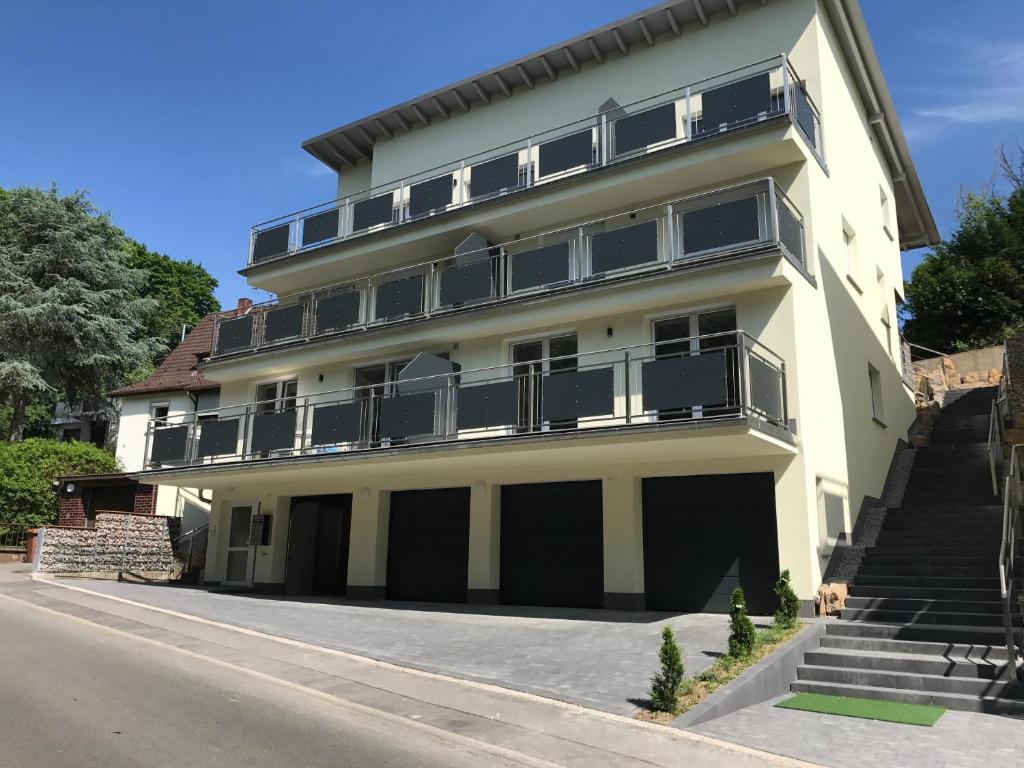 a large yellow building with balconies and a street at Appartement im Herzen von Leimen in Leimen