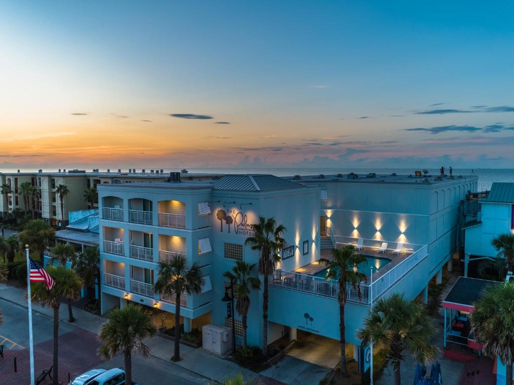 an aerial view of a hotel with palm trees and the ocean at The Palms Oceanfront Hotel in Isle of Palms