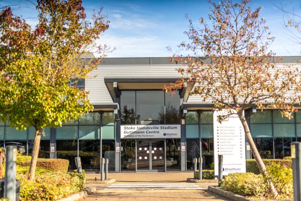 an external view of a building with trees at The Olympic Lodge in Aylesbury