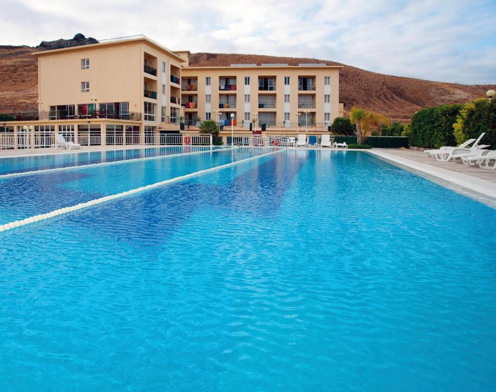 a large swimming pool in front of a hotel at INATEL Porto Santo in Porto Santo