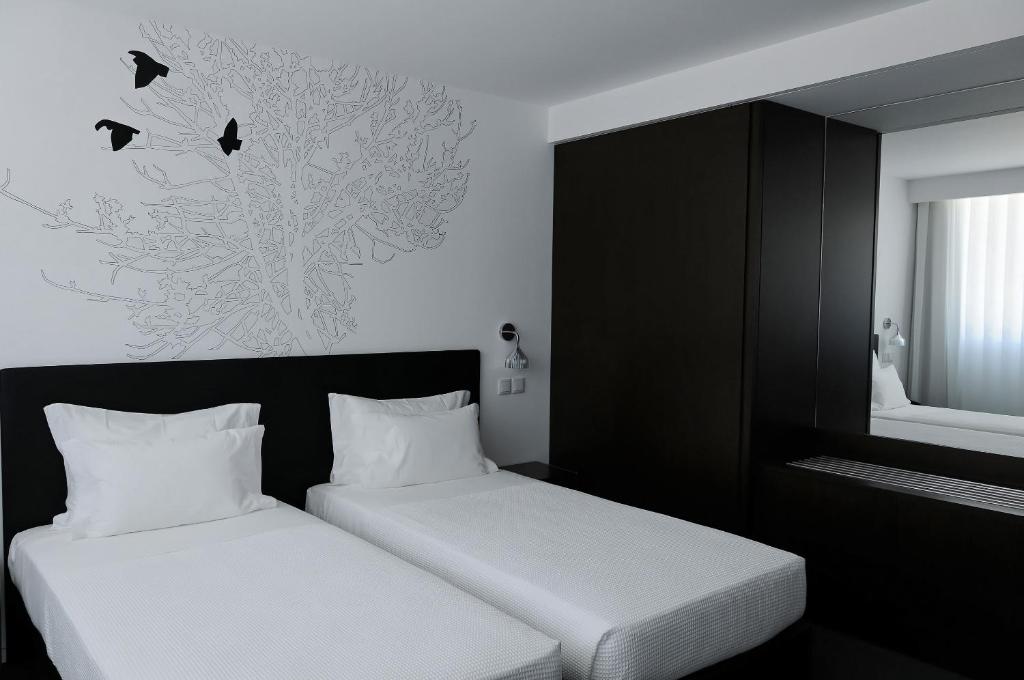 Postel nebo postele na pokoji v ubytování Open Village Sports Hotel & Spa Club