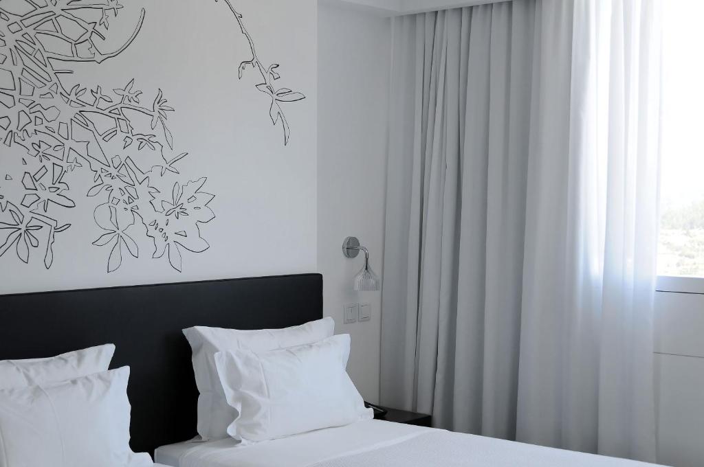 Postel nebo postele na pokoji v ubytování Open Village Sports Hotel & Spa Club