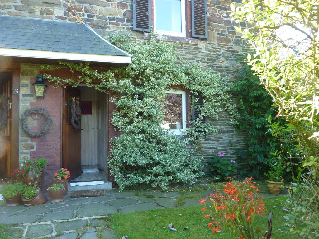 a brick house with ivy growing on the side of it at Au Jardin De Mon Père in Jalhay