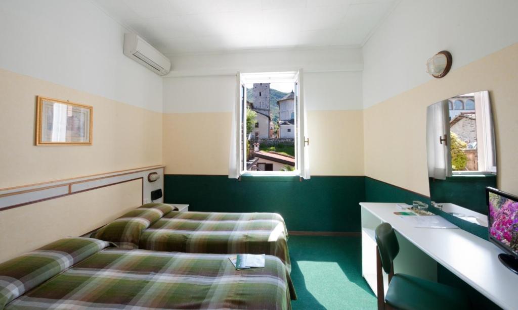 Een bed of bedden in een kamer bij Hotel Eden