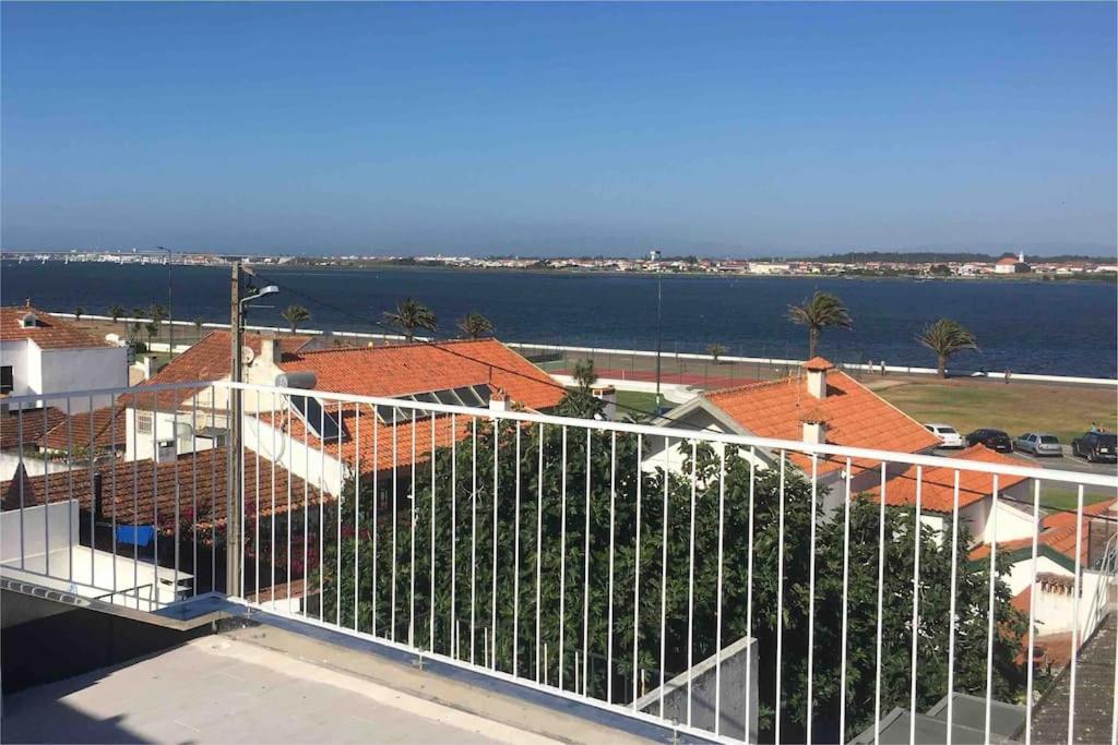 a balcony of a house with a view of the water at SEA RIA - A casa dos Maria in Costa Nova