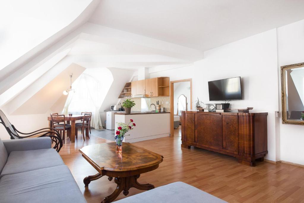 a living room with a couch and a table at Jacob Brno Apartments in Brno