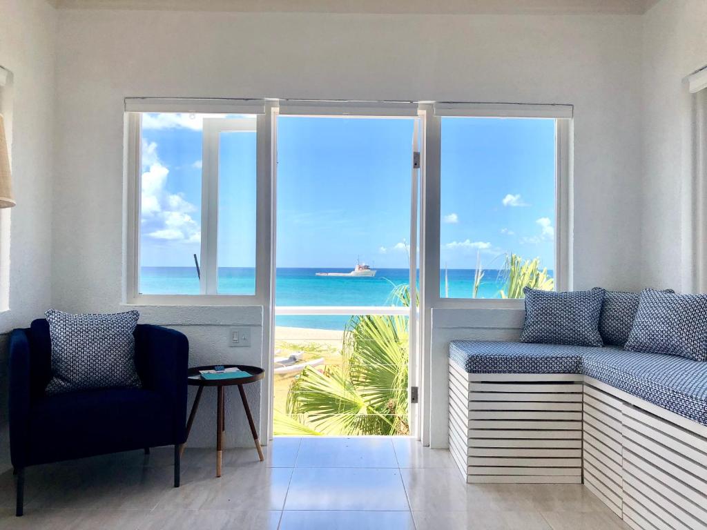 a room with a balcony with a view of the ocean at The Lighthouse in Cotton Ground