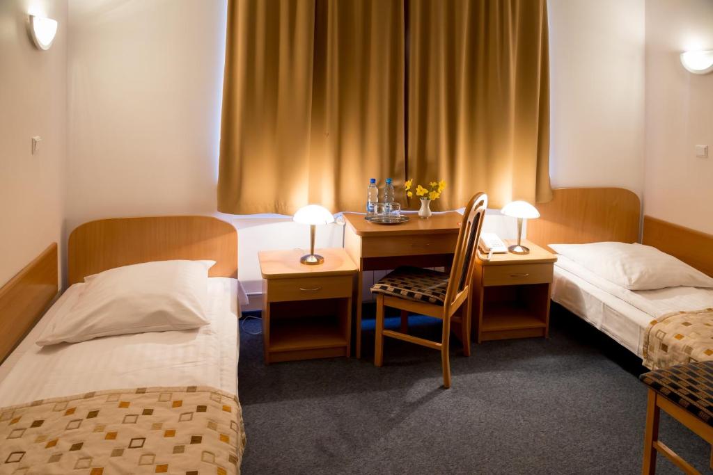 Postel nebo postele na pokoji v ubytování Kompleks Hotelowy Logos