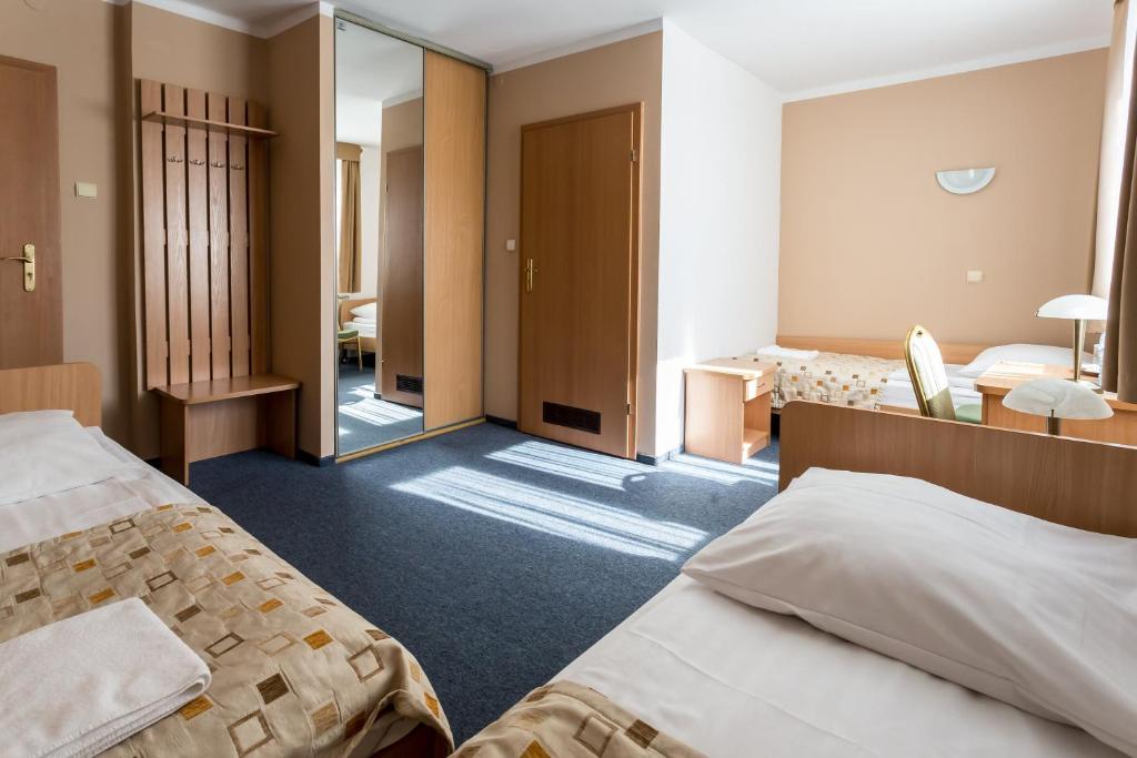 Postel nebo postele na pokoji v ubytování Kompleks Hotelowy Logos