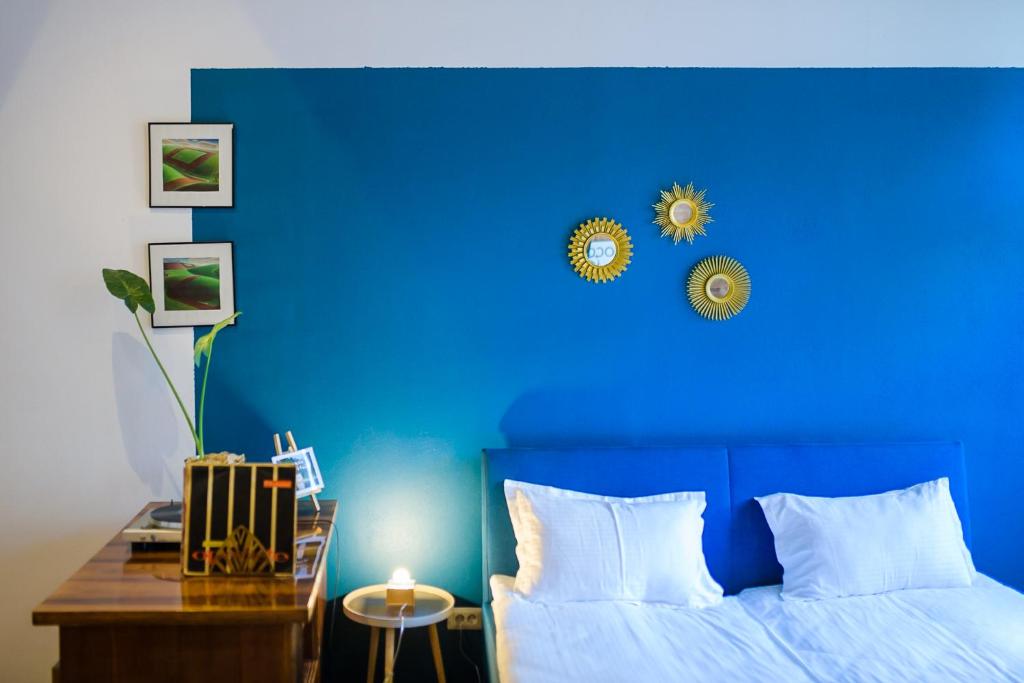 Dormitorio azul con cama y pared azul en Camino Home 2 en Cluj-Napoca