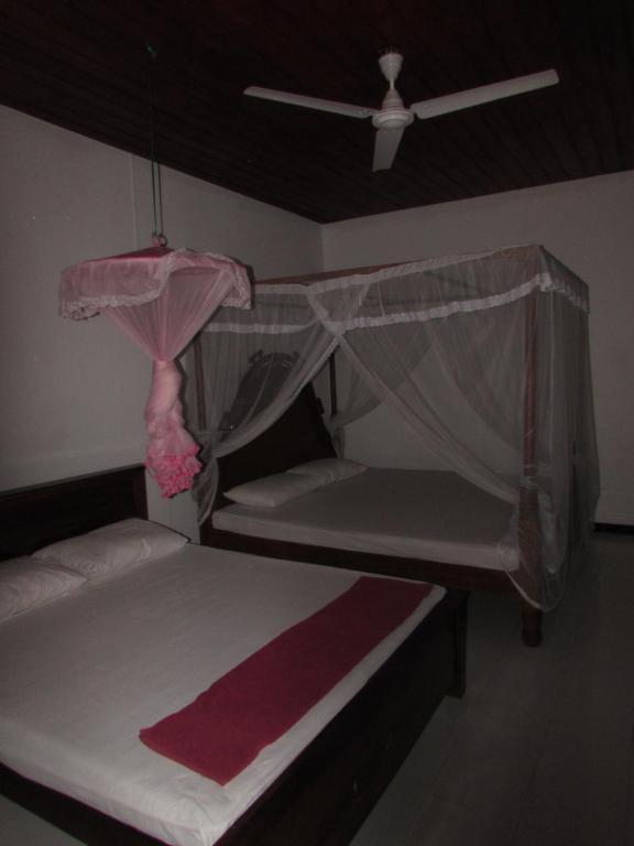 Postel nebo postele na pokoji v ubytování Rainbow Guest House