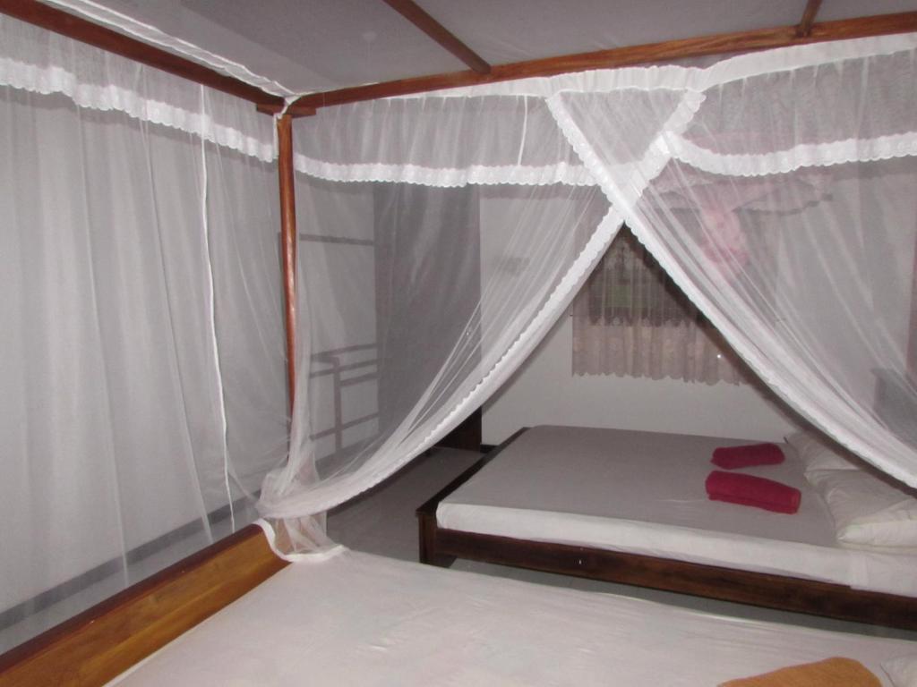 Postel nebo postele na pokoji v ubytování Rainbow Guest House