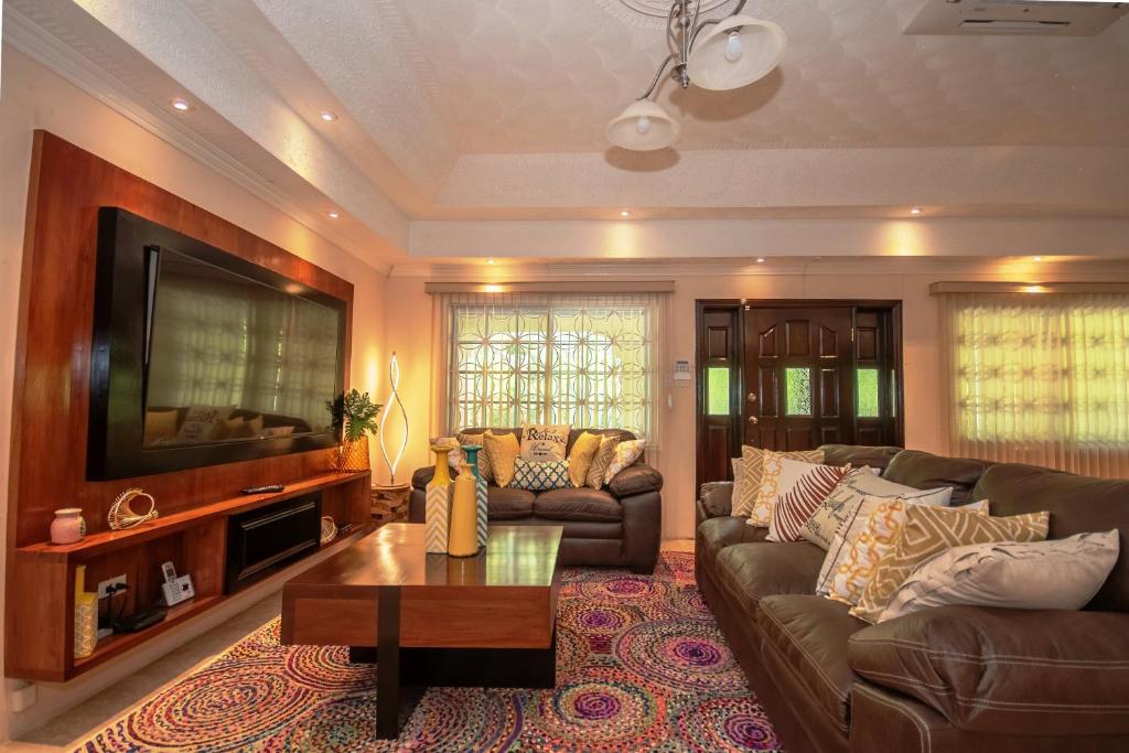 a living room with a couch and a coffee table at Tropical Escape Villa in Ocho Rios
